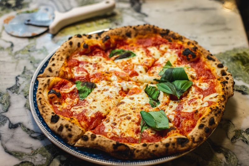 Hand-tossed classic cheese pizza at Daisy's Pizza in the Bronx